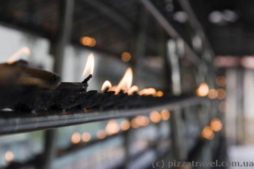 Visitors light the candles near the Temple of the Tooth.